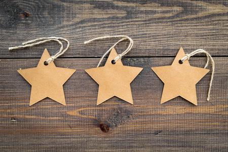 Figured blank tags for write price or discount on dark wooden background.の写真素材