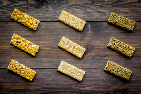 Granola bars for healthy nutritious breakfast on dark wooden background top view.の写真素材