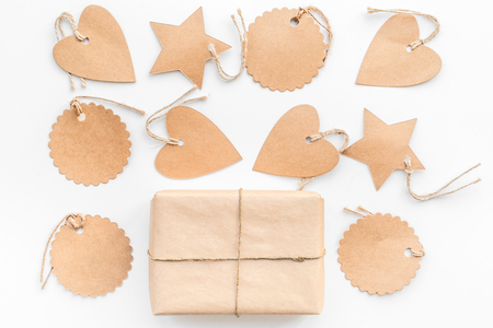 Parcel packaging box wrapped with craft paper with empty label mockup on white background top view.の写真素材