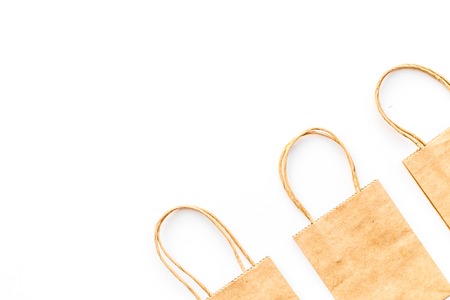 Brown kraft paper bag for shopping on white background top view copy space mockupの写真素材