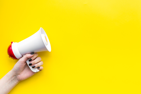 Megaphone make an announcement on yellow background top view.の写真素材