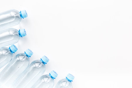Drinking water in bottles on white background top view.