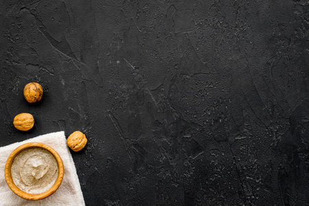 Homemade spa with organic scrub and walnut on dark background top view space for textの写真素材