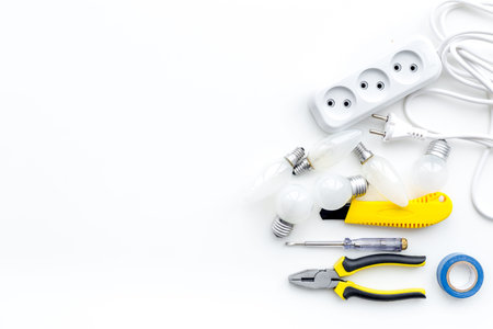 Electrical installation, wiring works. Tools and socket outlet on white background top view copy...