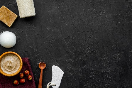 Treatment set with natural hazelnut scrub to take bath on dark background top view mock-upの写真素材