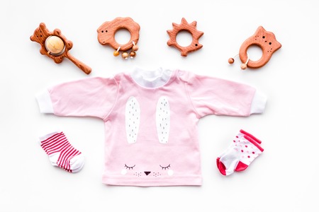 Newborn babys background. Clothes for small girl with booties on white top viewの写真素材