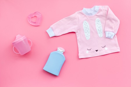 Child birth concept. Clothes and accessories for newborn on pink background top view.の写真素材