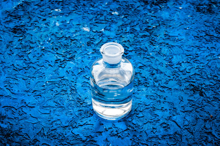 Drinks on the table. Pure water in jar and glasses on blue background.