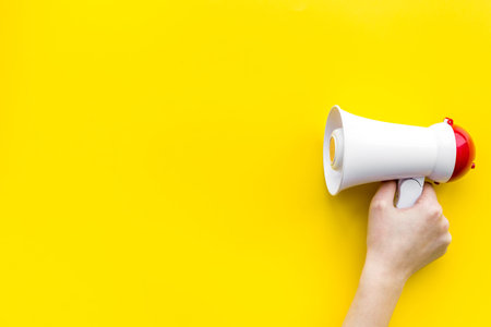 Attract attention concept. Megaphone in hand top view copy spaceの写真素材