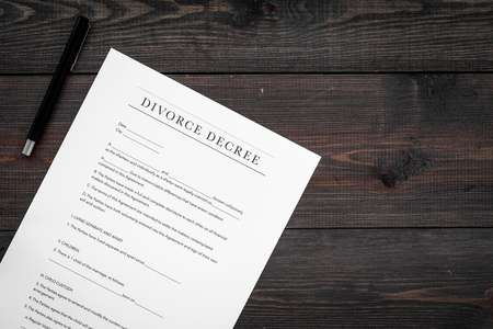 Divorce decree. Document on dark wooden backgroud top viewの写真素材