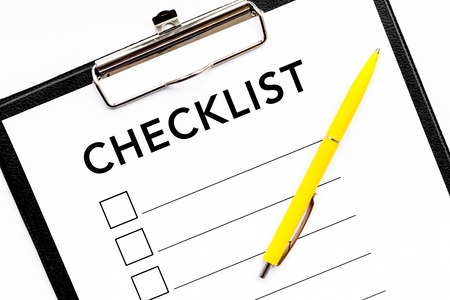 Blank checklist with space for ticks on pad on office desk. Checklist for office worker, manager, businessman, chief on white background top view.の写真素材