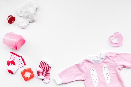 Newborn baby's background. Clothes for small girl with booties on white top view.の写真素材