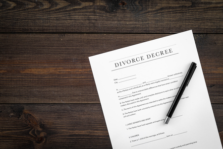 Divorce decree. Document on dark wooden background top viewの写真素材