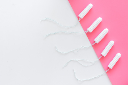 Woman hygiene protection. Cotton tampons on pink background top view.の写真素材