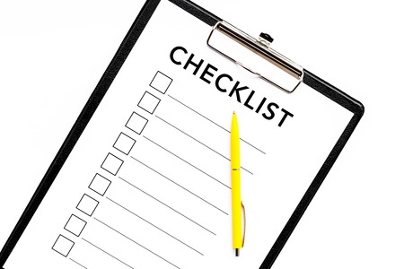 Blank checklist with space for ticks on pad on office desk. Checklist for office worker, manager, businessman, chief on white background top view closeupの写真素材