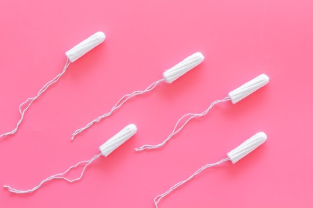 Woman hygiene protection. Cotton tampons like sperms on pink background top view.の写真素材