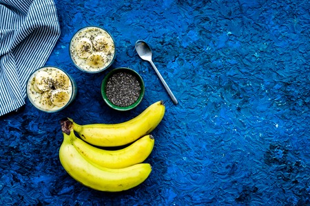 Homemade banana pudding with chia seeds on blue background with blue tablecloth top view copy spaceの写真素材