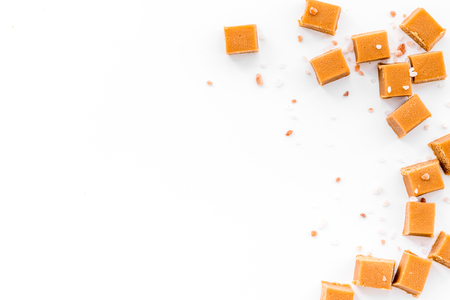 Salted caramel. Caramel cubes on white background top view.の写真素材