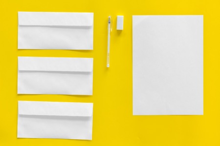 Blank stationery for branding on yellow background top view.