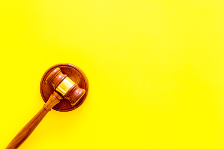 Lawyer or attorney concept. Judge gavel on yellow background top view copy spaceの写真素材