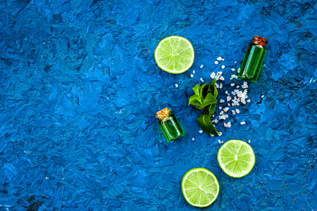 Citrus oil with lemon or lime for aromatherapy or skin care on blue background top view copy spaceの写真素材