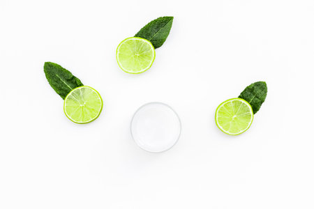Organic citrus cosmetics for skin care. Lemon or lime moisturizing cream on white background top...