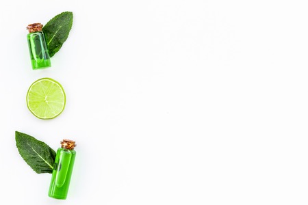 Citrus oil with lemon or lime for aromatherapy or skin care on white background top view copy spaceの写真素材