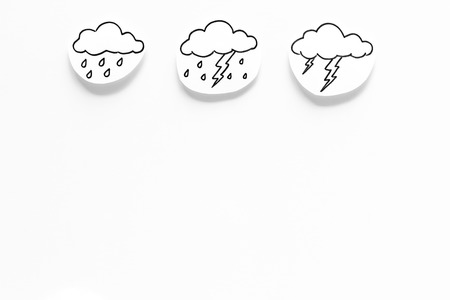 Rainfall forecast concept. Weather icons. Rainy cloud, lightening on white background top view copy spaceの写真素材