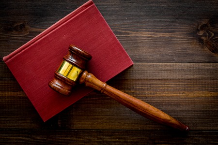 Law student concept. Judge gavel and vintage books on dark wooden background top view copy spaceの写真素材