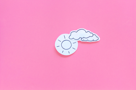 Clear and cloudy weather icons on pink background top view copy spaceの写真素材