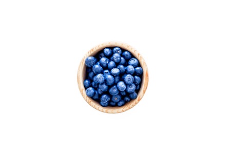 Fresh recently picked blueberries in bowl on white background top view copy spaceの写真素材