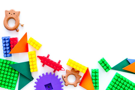 Educational toys farme. Plastic lego blocks and clacks on white background top view.