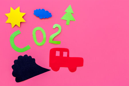 Cars emitting carbon dioxide. Pollution conept. harm the environment. Car and smoke cutout on pink background top view copy spaceの写真素材