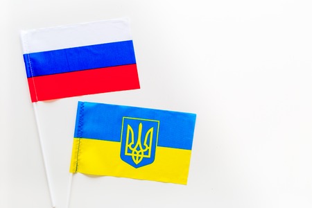 Russia-Ukraine relations. Country cooperation. Russian and Ukrainian flags on white background top view copy spaceの写真素材