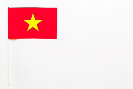 Vietnamese flag concept. Small flag on white background top view copy spaceの写真素材