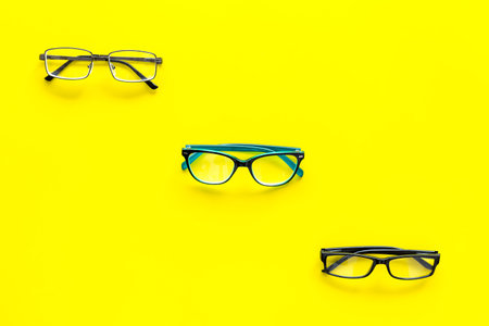 Glasses concept. Set of glasses with different eyeglass frame and transparent lenses on yellow...