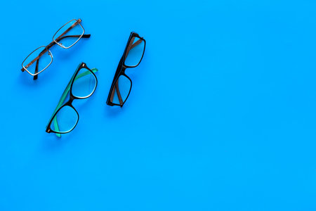Glasses concept. Set of glasses with different eyeglass frame and transparent lenses on blue...