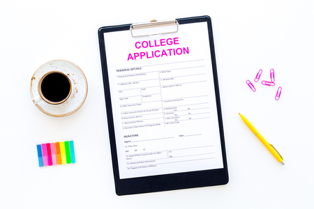 Higher education. College application form ready to fill near coffee cup and stationery on white background top viewの写真素材
