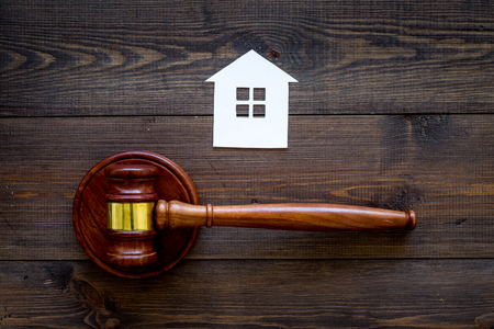 House cutout near judge gavel on dark wooden background top view copy space. Housing law. Property division. Real estate auctionの写真素材