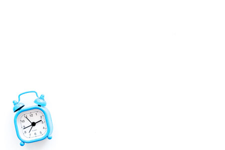 Alarm clock for for waking up on white background top view.