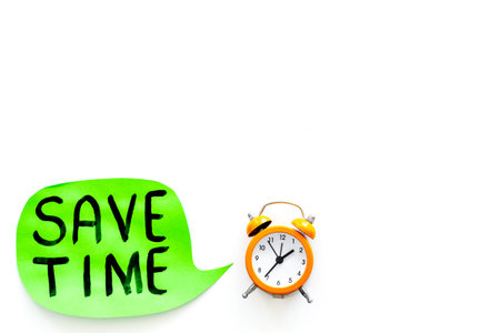 Time-management. Save time hand lettering in cloud near alarm clock on white background top view.の写真素材