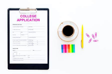 Apply college. Empty college application form near coffee cup and stationery on white background top view space for textの写真素材