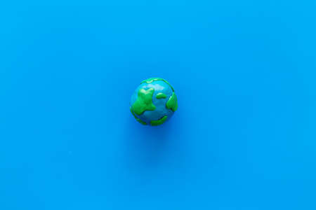 Planet, ecology. Plasticine symbol of planet Earth globe on blue background top view.の写真素材