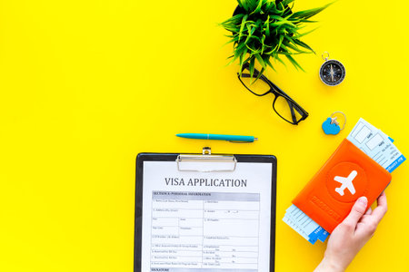 Planning vacation. Visa processing. Hand hold airplane tickets in passport cover with airplane...