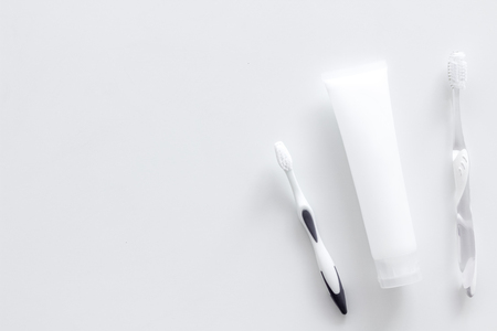 Clean teeth. Toothbrushes and tooth paste on white background top view.の写真素材