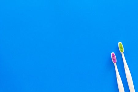 Clean teeth. Toothbrushes on blue background top view.の写真素材
