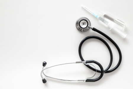 Infuenza vaccine in syringe near stethoscope on white background top view.の写真素材