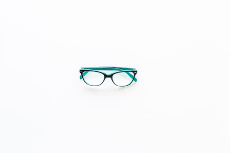 Glasses with transparent optical lenses on white background top view.