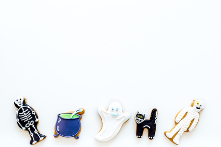Halloween traditions. Halloween gingerbread in shape of evil characters on white background top view copy spaceの写真素材