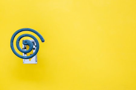 Mosquito repellent for outdoor: garden, summer house, picnic. Green spiral on yellow background top...